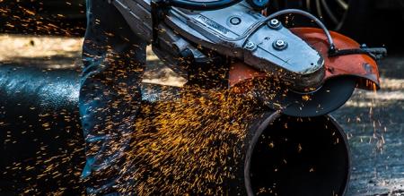 Pipe being cut with sparks