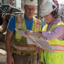 Two construction workers examining the site plan
